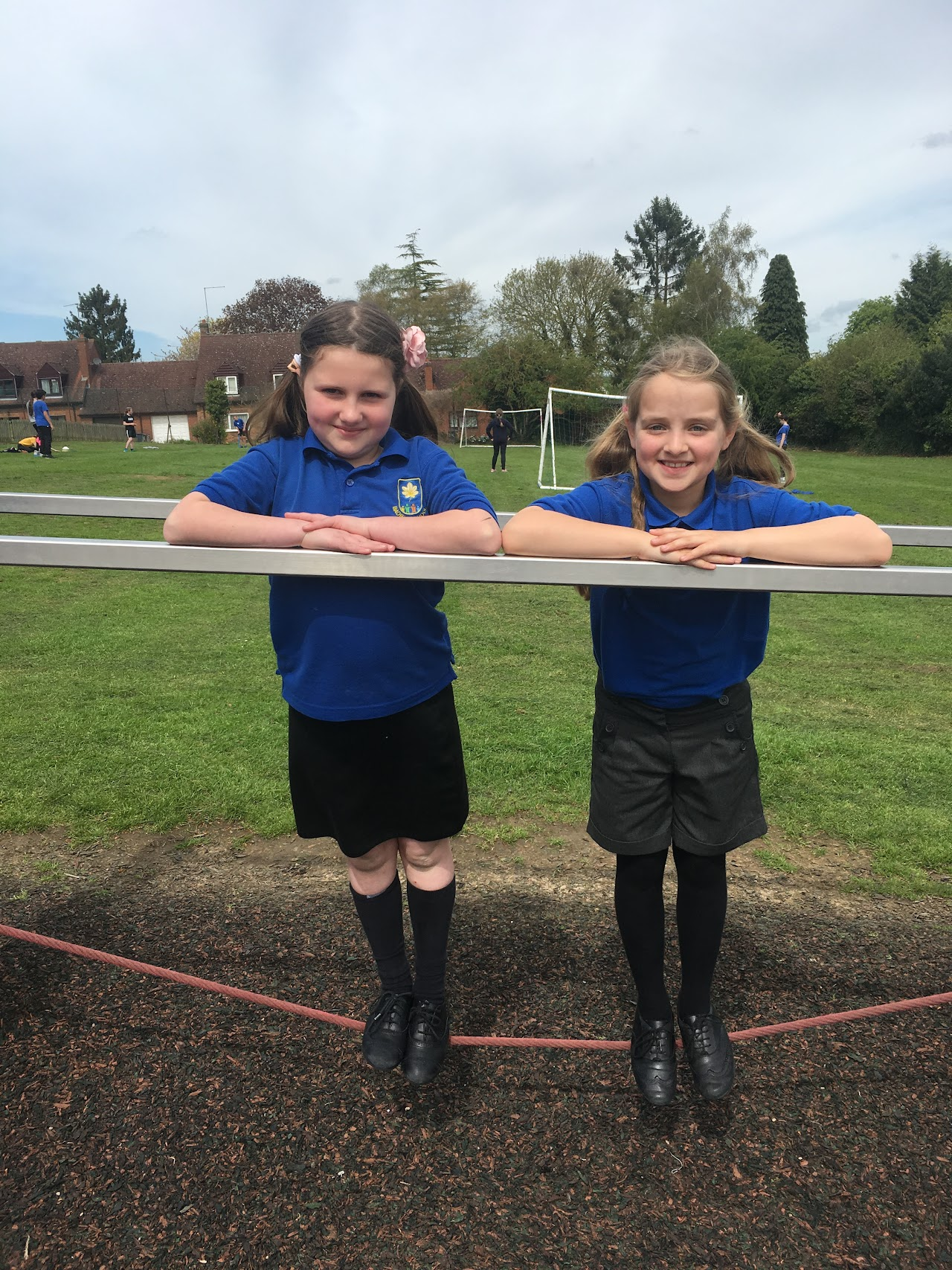 Two pupils wearing blue Badby polo t-shirts